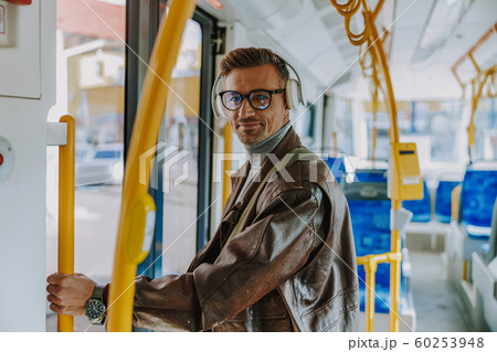 Handsome stylish man standing inside the tram Handsome stylish man standing inside the tram 60253948