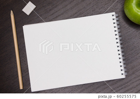 Top view. Mock up. Blank white sheet on a dark background for notes. 60255575
