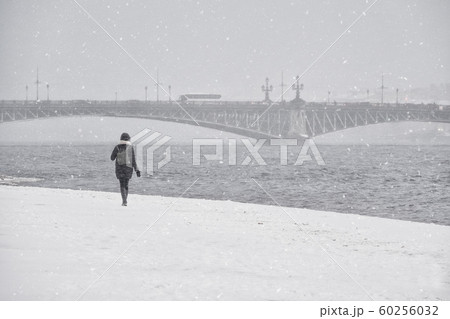 Woman under the snow in St. Petersburg. Russia.  60256032