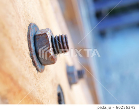 Close up of old nuts and screws on wooden posts On a wooden floor background With copy space. Selective focus 60256245