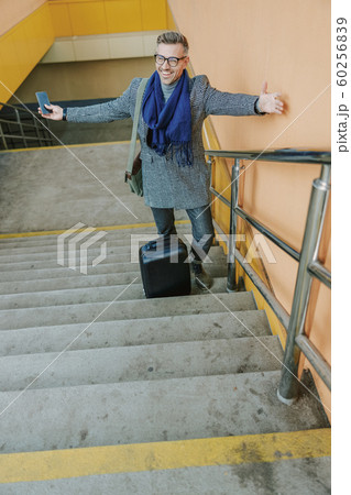 Happy elegant man spreading hands to greet a friend 60256839