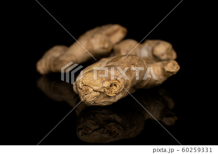 Fresh brown ginger isolated on black glass Fresh brown ginger isolated on black glass 60259331