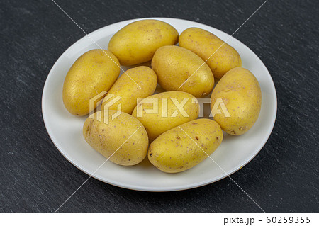 Yellow pale potato on grey stone Yellow pale potato on grey stone 60259355
