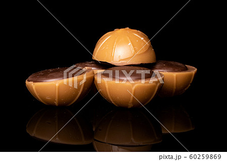 Sweet brown toffee isolated on black glass Sweet brown toffee isolated on black glass 60259869