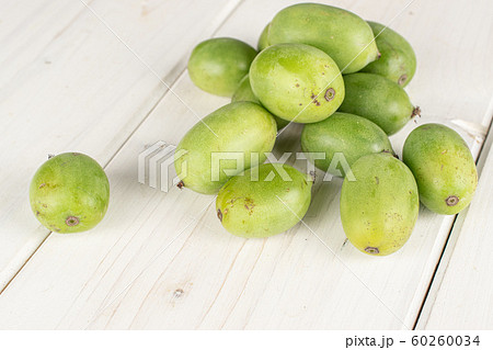 Hardy green kiwi on grey wood 60260034