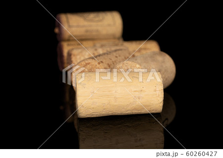Common wine cork isolated on black glass Common wine cork isolated on black glass 60260427