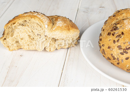 Sesame kaiser roll on grey wood Sesame kaiser roll on grey wood 60261530