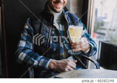 Cropped photo of Caucasian guy having rest in cafe Cropped photo of Caucasian guy having rest in cafe 60262248