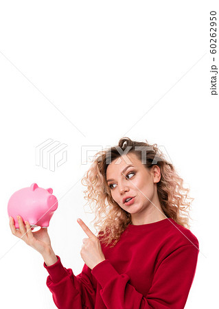 attractive girl talking with a piggy bank in hands on a white studio background attractive girl talking with a piggy bank in hands on a white studio background 60262950