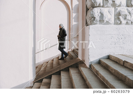 Adult man is going downstairs in city 60263079