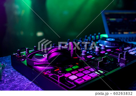DJ music mixer and professional headphones in the nightclub 60263832