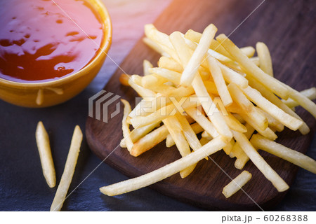 french fries ketchup in wooden board with black french fries ketchup in wooden board with black 60268388