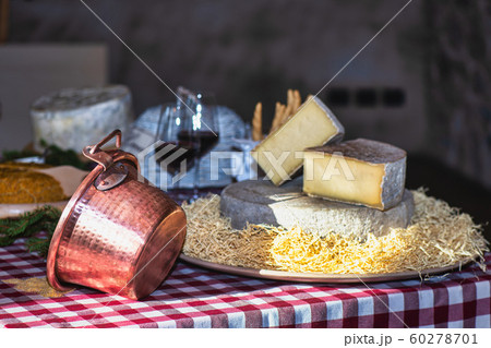 Copper pot on table with cheese typical of the Copper pot on table with cheese typical of the 60278701