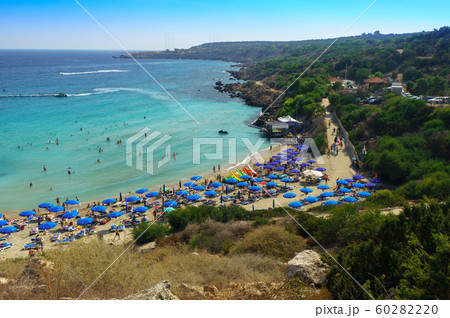 People at the famous beach of Konnos Bay Beach, Ayia Napa. Famagusta District, Cyprus. Best beaches of Cyprus - Konnos Bay in Cape Greko national park People at the famous beach of Konnos Bay Beach, Ayia Napa. Famagusta District, Cyprus. Best beaches of Cyprus - Konnos Bay in Cape Greko national park 60282220