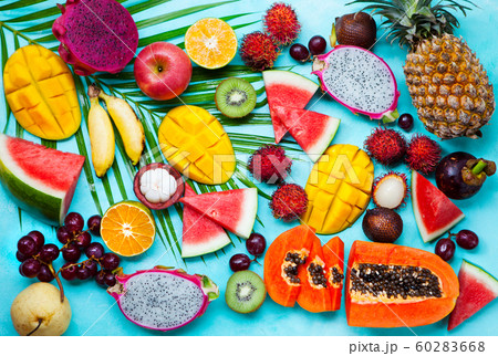 Assortment of tropical exotic fruits. Blue background. Top view. 60283668