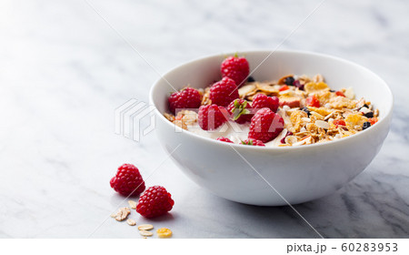 Healthy breakfast. Fresh granola, muesli with yogurt and berries. Marble background. Close up. Copy space. Healthy breakfast. Fresh granola, muesli with yogurt and berries. Marble background. Close up. Copy space. 60283953