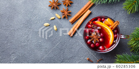 Mulled red wine with spices. Christmas decoration. Grey background. Copy space. Top view. Mulled red wine with spices. Christmas decoration. Grey background. Copy space. Top view. 60285306