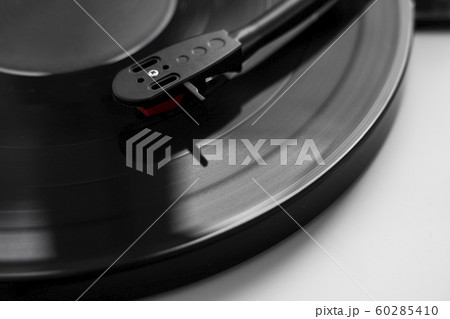Vinyl turntable on a white background. Retro audio equipment for vinyl disk. Vinyl turntable on a white background. Retro audio equipment for vinyl disk. 60285410