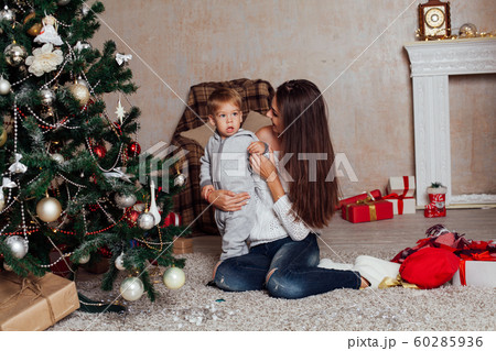 mother and little boy at Christmas tree with gifts 1 mother and little boy at Christmas tree with gifts 1 60285936