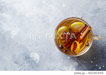 Apple mulled cider with spices in glass cup. Grey background. Copy spase. Top view. 60285949