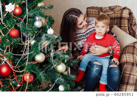 mom with son decorate tree on new year's Gifts Christmas mom with son decorate tree on new year's Gifts Christmas 60285951