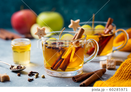 Apple mulled cider with spices in glass cup. Grey stone background. Close up. 60285971