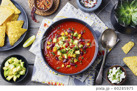 Mexican tomato, bean, bell pepper soup in black bowl. Top view. Mexican tomato, bean, bell pepper soup in black bowl. Top view. 60285975