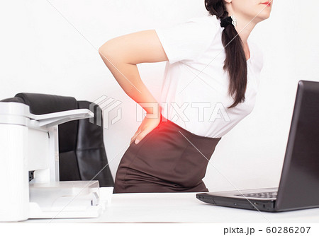girl office worker holding her aching back from a chair, the concept of back pain in office workers, lactic acid in muscles and spinal problems, lumbago girl office worker holding her aching back from a chair, the concept of back pain in office workers, lactic acid in muscles and spinal problems, lumbago 60286207