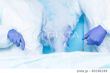 Two surgeons of Hiurge do surgery using liquid nitrogen cryotherapy to remove malignant tumors, tumors. Modern method of treatment cryosurgery, hemorrhoids Two surgeons of Hiurge do surgery using liquid nitrogen cryotherapy to remove malignant tumors, tumors. Modern method of treatment cryosurgery, hemorrhoids 60286289