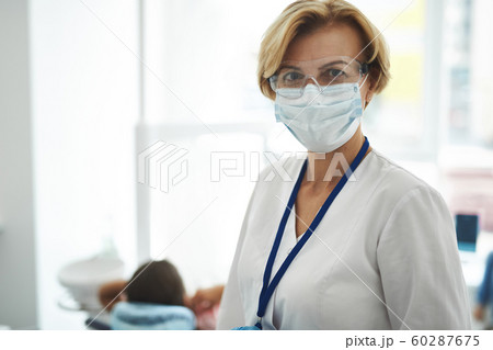 Adult female dentist is working in clinic Adult female dentist is working in clinic 60287675