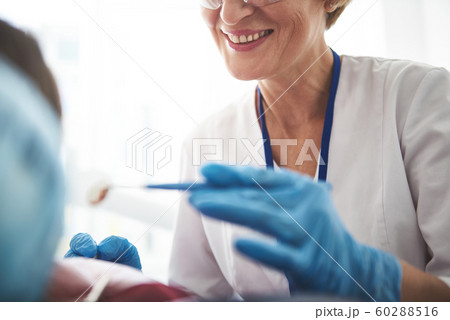 Close up of a smiling stomatologist enjoying her work 60288516