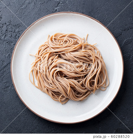 Soba noodles on a white plate. Japanese food. Black slate background. Top view. 60288520