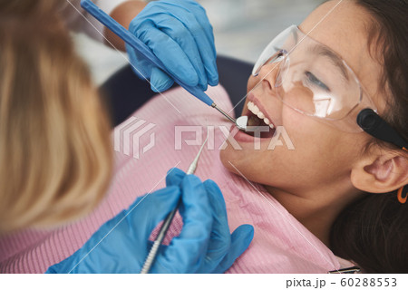 Close up of a nice little girl visiting her stomatologist Close up of a nice little girl visiting her stomatologist 60288553
