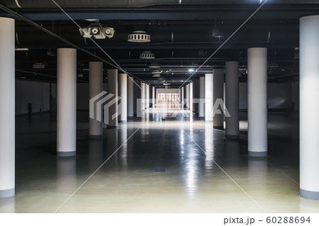 long corridor with round columns in the basement 60288694