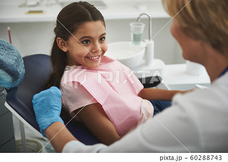 Close up of a smiling little girl visiting her stomatologist Close up of a smiling little girl visiting her stomatologist 60288743