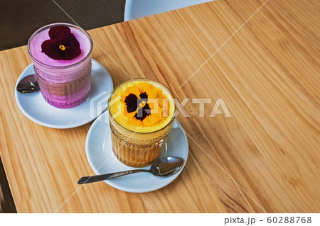 Two glasses of coffee latte with colorful foam 60288768