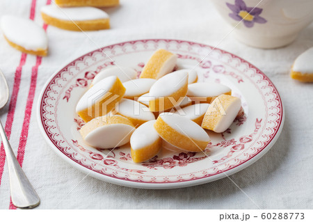 Calissons traditional French Provence sweets on a plate. Tablecloth background. Close up. 60288773