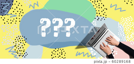 Question marks with person using laptop 60289168