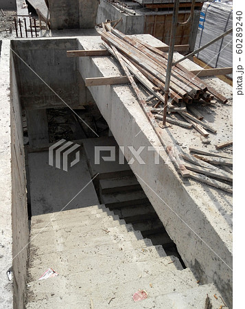 Concrete staircase under construction at the construction site. Timber formwork fabricated by construction workers as the staircase mold. 60289240