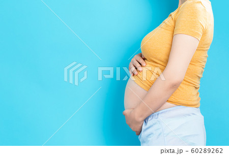 Pregnant woman on a solid background Pregnant woman on a solid background 60289262