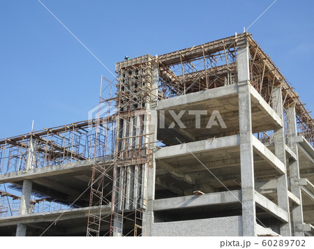 Building reinforcement concrete structure at the construction site. Post, beam and slab constructed using timber formwork by construction workers.  60289702