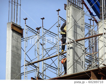 Building reinforcement concrete structure at the construction site. Post, beam and slab constructed using timber formwork by construction workers.  60289710