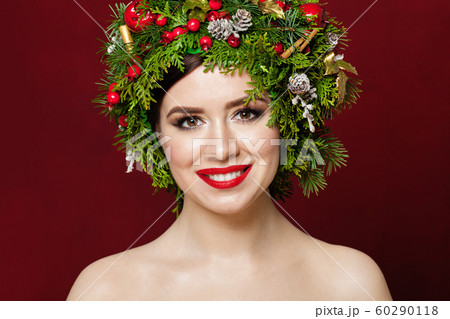 Beautiful woman wearing Christmas decorations Beautiful woman wearing Christmas decorations 60290118