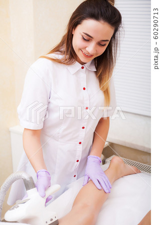 Body Care. Beautician Giving Epilation Laser Treatment To Woman On Leg 60290713