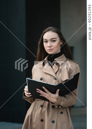 Self-confidence young business woman with file in a hand. outdoor. cityscape Self-confidence young business woman with file in a hand. outdoor. cityscape 60291393