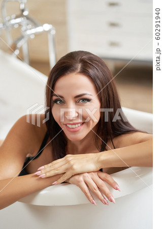 Portrait smiling gorgeous female relaxing in bath Portrait smiling gorgeous female relaxing in bath 60291940