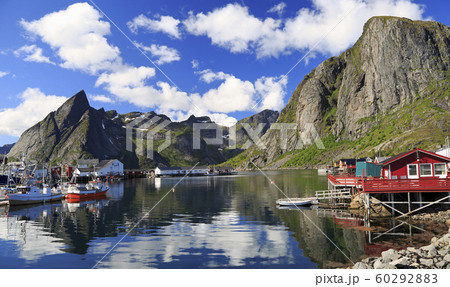 Traditional Norwegian fishing boats in Lofoten Island, Queen area with nice reflections in the ocean fjord Traditional Norwegian fishing boats in Lofoten Island, Queen area with nice reflections in the ocean fjord 60292883