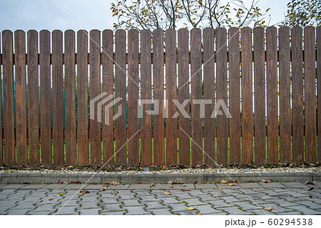 wooden fence in front of green garden of family house wooden fence in front of green garden of family house 60294538