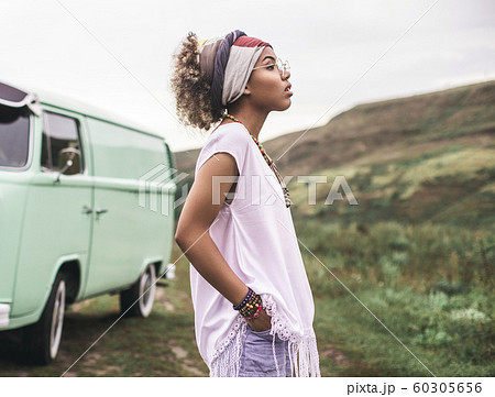 Thoughtful ethnicity female stay near retro van Thoughtful ethnicity female stay near retro van 60305656