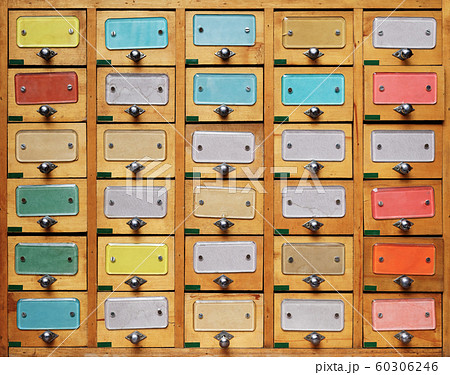 Vintage wooden cabinet with multicolor labels Vintage wooden cabinet with multicolor labels 60306246